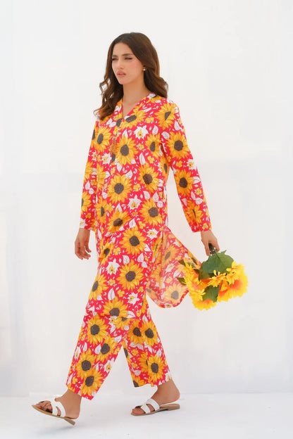 Women's floral kurta set with sunflower print, long sleeves and matching pants, walking shot