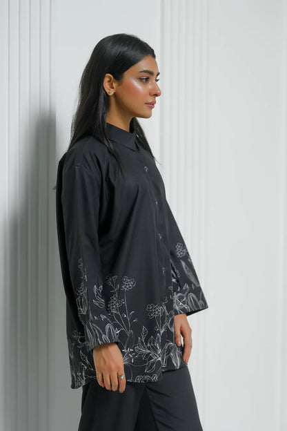 Black button-up tunic with floral print panel near hem, side profile