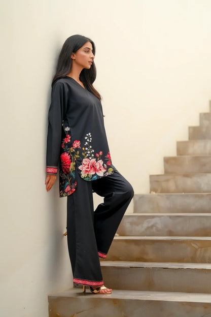 Dhaga black long-sleeve tunic with floral border detail; black pants with red trim