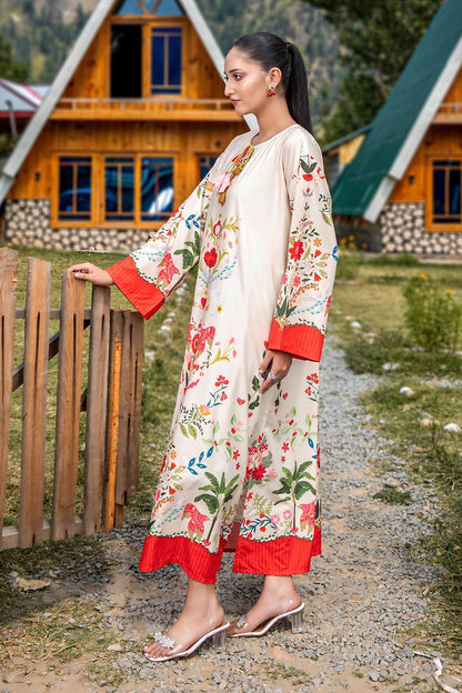 Floral embroidered long dress in cream with red cuff and hem trim, side view.
