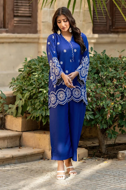 Blue kurta set with white border patterns and matching straight pants