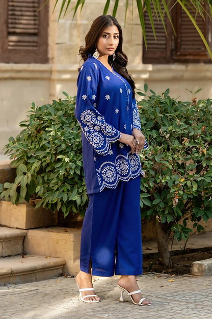 Blue three-quarter sleeve kurta with white motifs, paired with matching pants