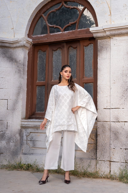 White embroidered tunic with wide cape sleeves and matching white cropped pants