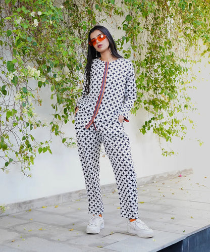 Geometric print long-sleeve jumpsuit with orange-trim placket and patterned pants