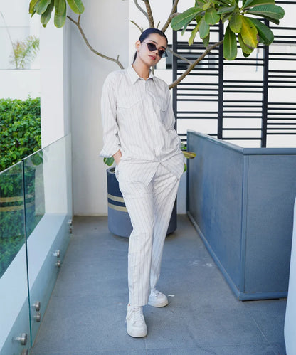 Light striped button-up shirt and matching pinstripe trousers set, long sleeves
