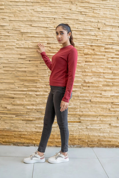 Women's maroon long-sleeve top with crew neck and fitted cuffs