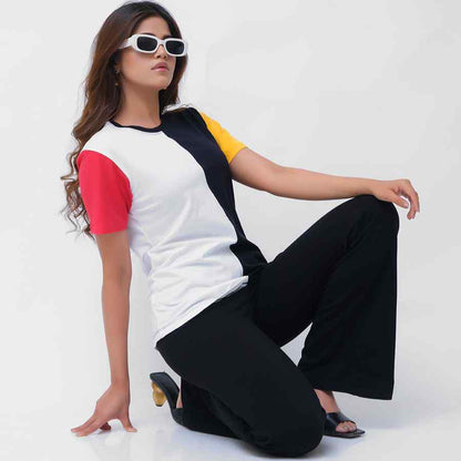Colorblock raglan T-shirt with black and white panels, red/yellow sleeves; black pants