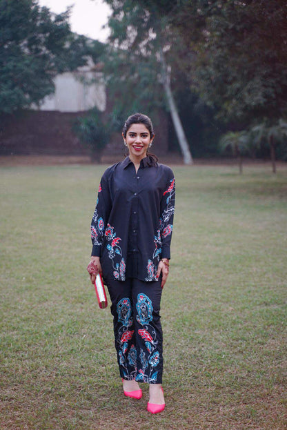 Dark kurta with button placket, floral embroidery on sleeves and all-over printed pants