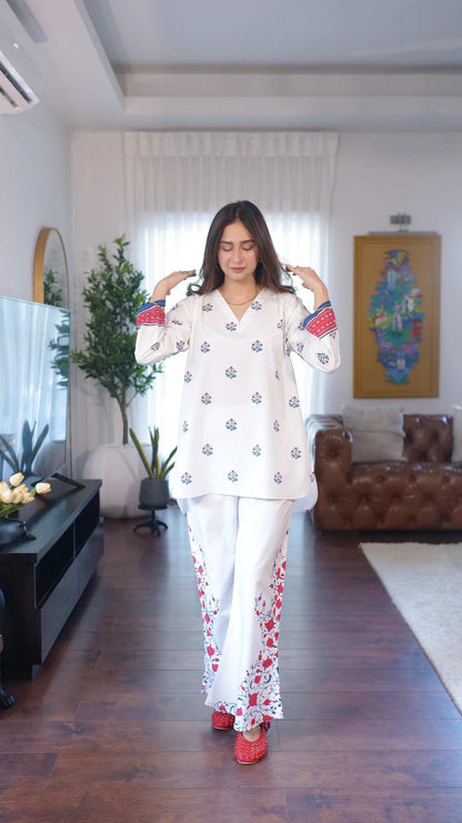 Printed pajama set with V-neck tunic top and matching pants, blue and red motifs