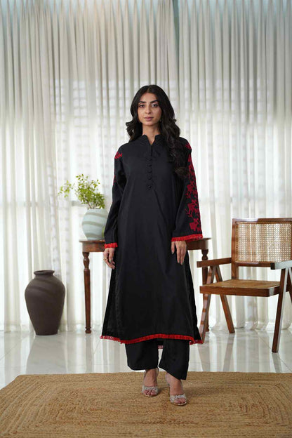 Dhaga black kurta and pants set with red floral trims at sleeves and hem