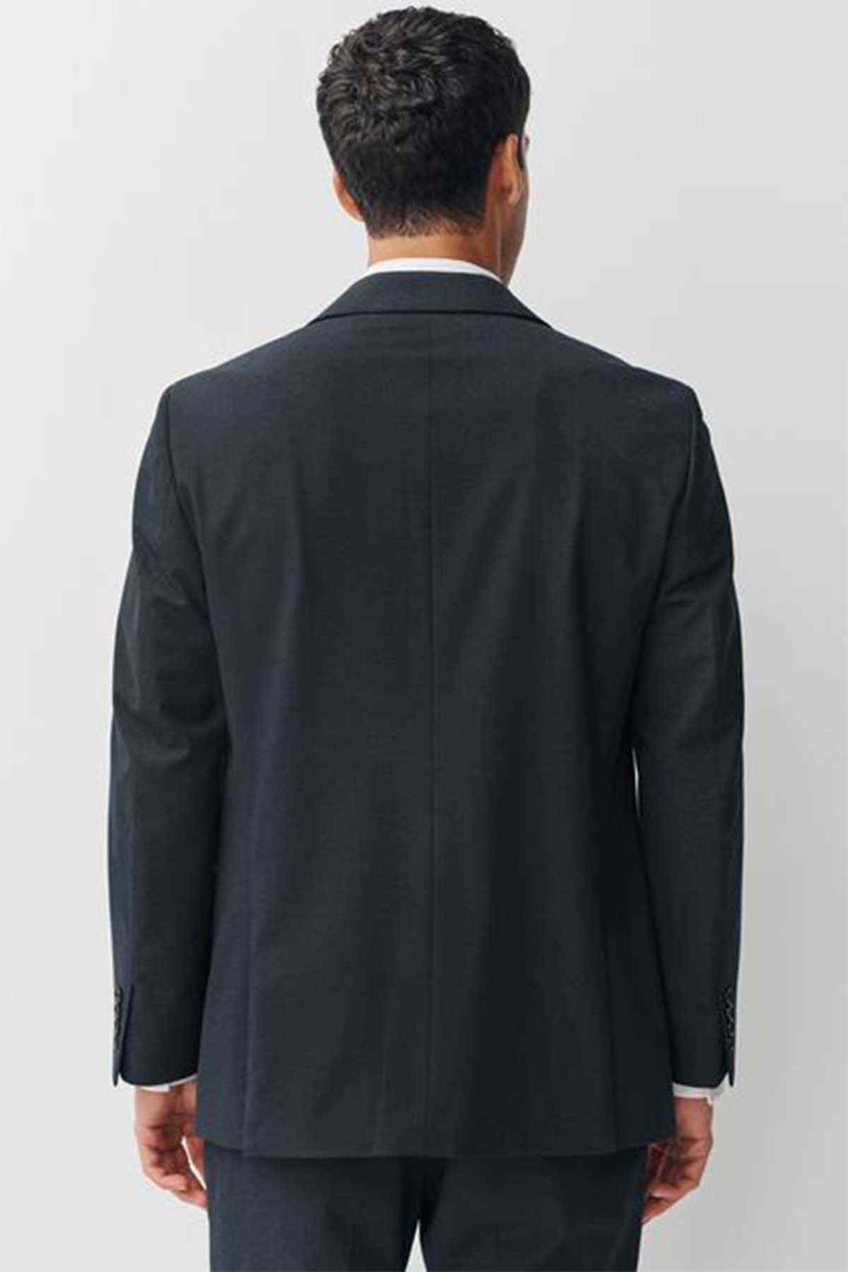 Navy suit jacket back view with center seam and buttoned cuffs