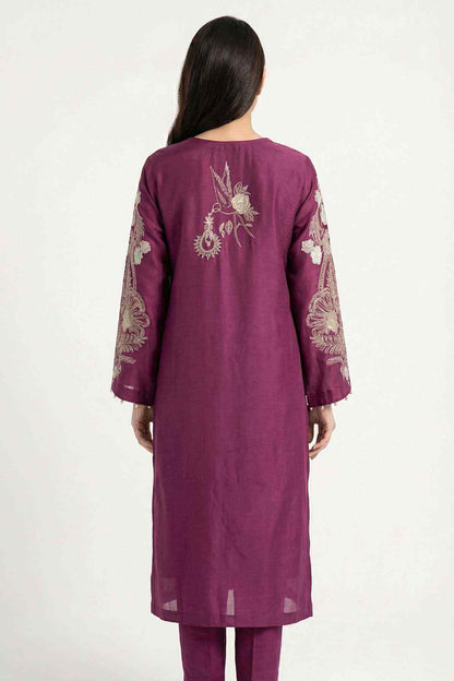 Plum kurta with embroidered back motif and three-quarter sleeves, worn with slim pants.