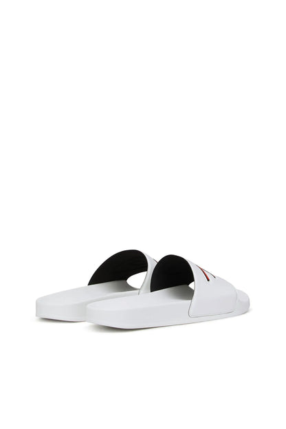 White slide sandals with black footbed lining and orange-red Diesel logo straps