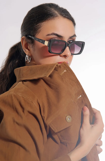 Tan button-front utility jacket with chest pockets, worn close-up with sunglasses
