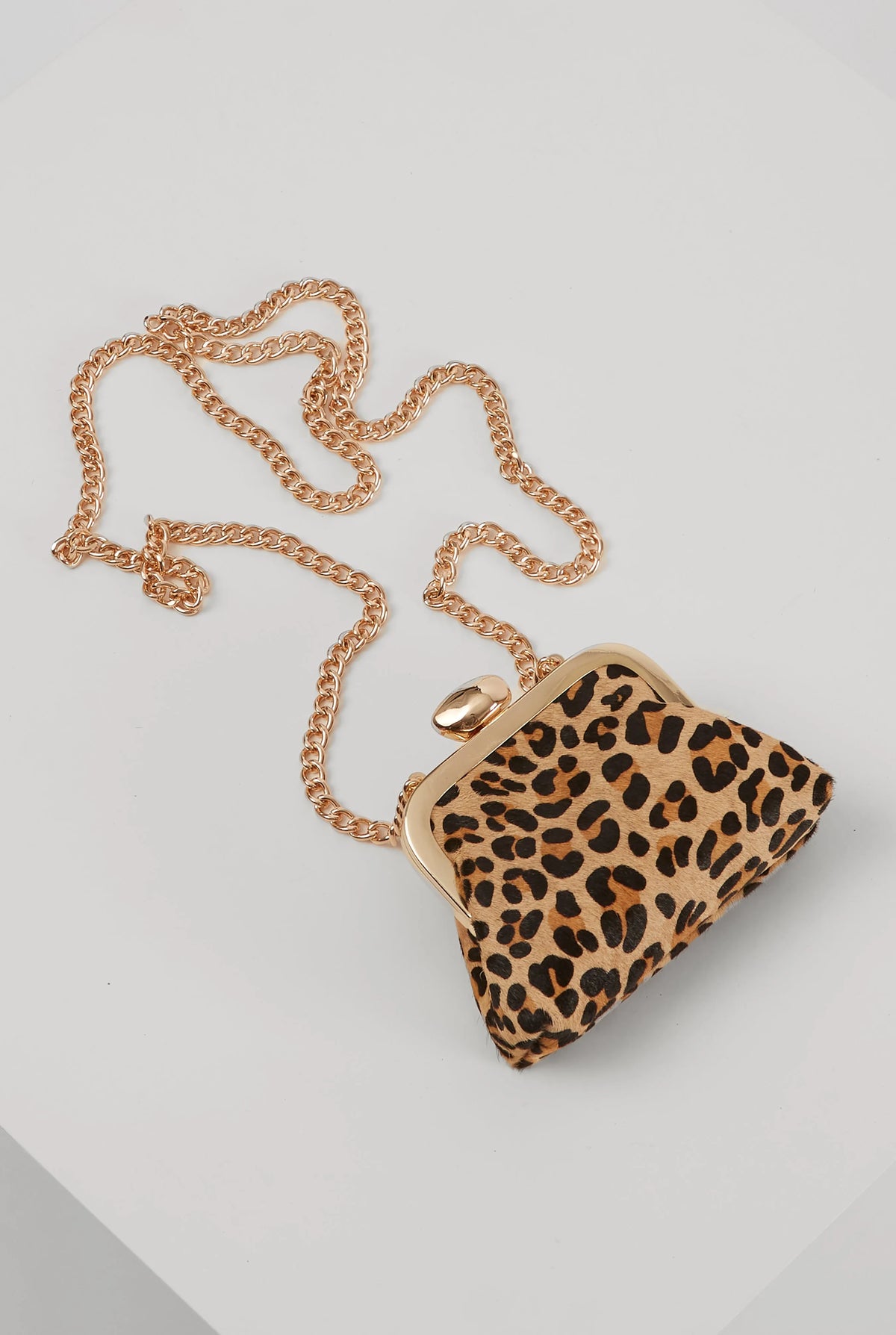 Leopard-print mini handbag with gold clasp and dangling gold chain strap