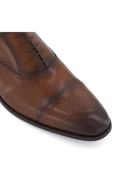 Close-up of dark tan lace-up oxford toe and lace stitching details