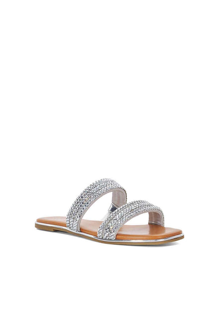 Silver rhinestone slide sandal with crisscross straps and tan footbed, flat slide sole