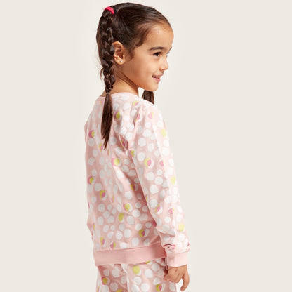 Kids' pink dotted pajama set with long sleeves and matching pants, side view