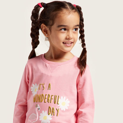 Pink crew-neck kids sweatshirt with “It’s a wonderful day” daisy graphic