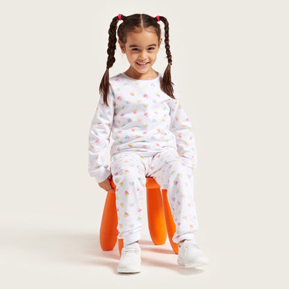 Kids pajama set with white long-sleeve top and patterned pants, multicolor heart print