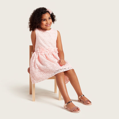 Pink sleeveless girls dress with subtle dotted print and gathered skirt