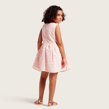 Pink sleeveless girls dress with dotted print, back/side view