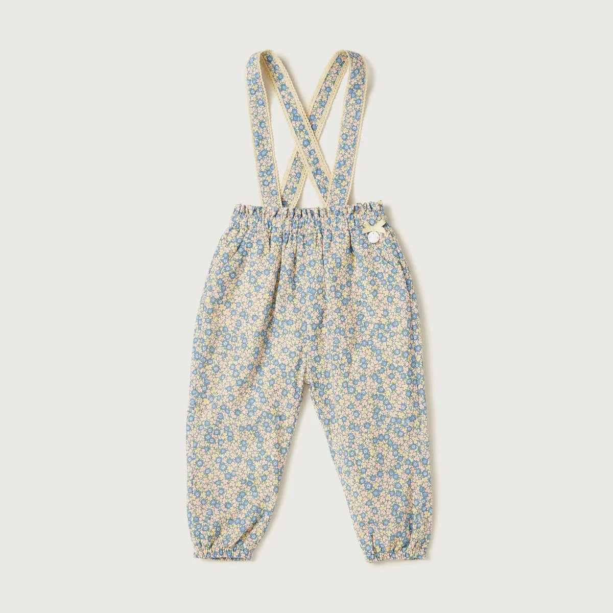 Blue floral suspender overalls for baby with X-back straps and button closure