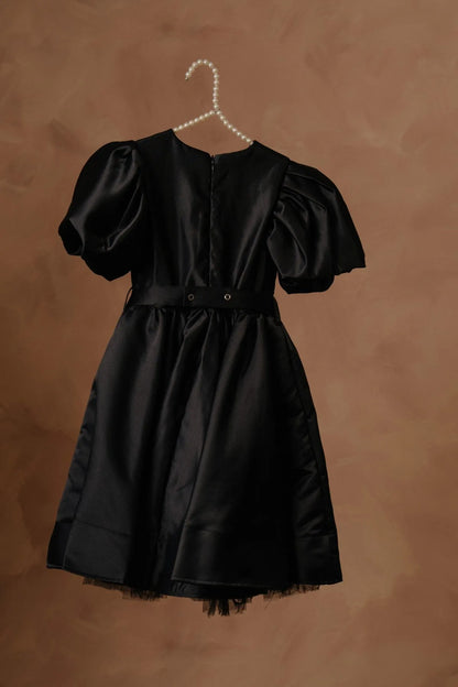 Black puff-sleeve dress with buttoned back, bow waist, tulle-trim skirt