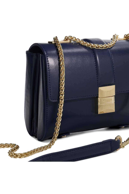Dune London navy flap bag side view with gold chain strap and lock clasp