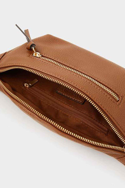 Tan belt bag close-up showing double zippers and inner pocket