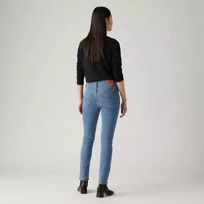 Medium indigo denim jeans on model, back view, straight leg