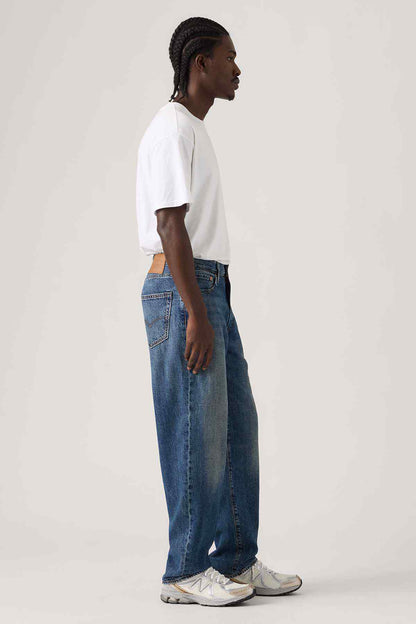 Dark wash denim jeans with relaxed straight fit and visible side seam