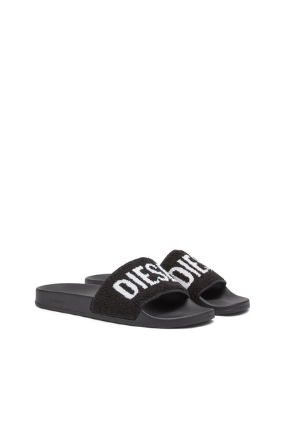 Black slide sandals with wide fuzzy strap and white DIESEL logo