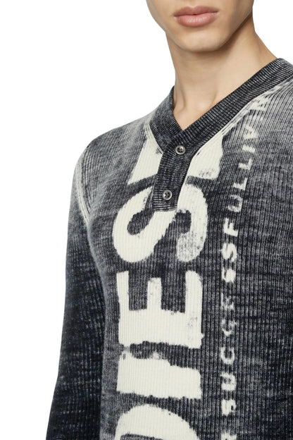 Diesel henley sweater close-up: dark gray knit with large white graphic and button placket