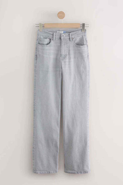 Pair of light grey wide-leg denim jeans hanging on a wooden hanger