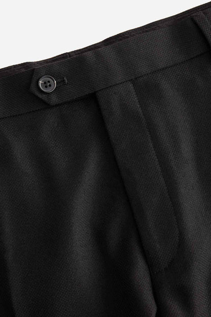 Black trouser fly button and fabric texture close-up