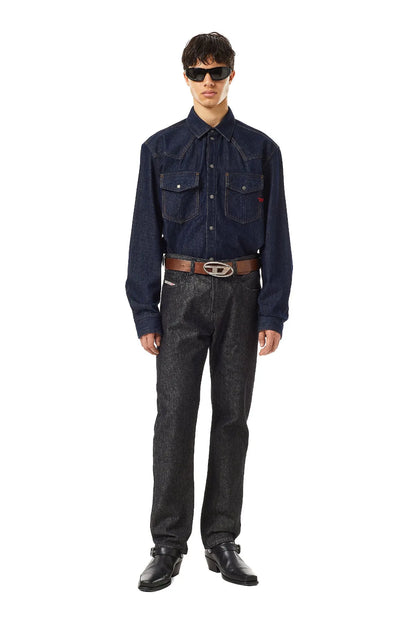Diesel black denim jeans on model, full-length front view with belt