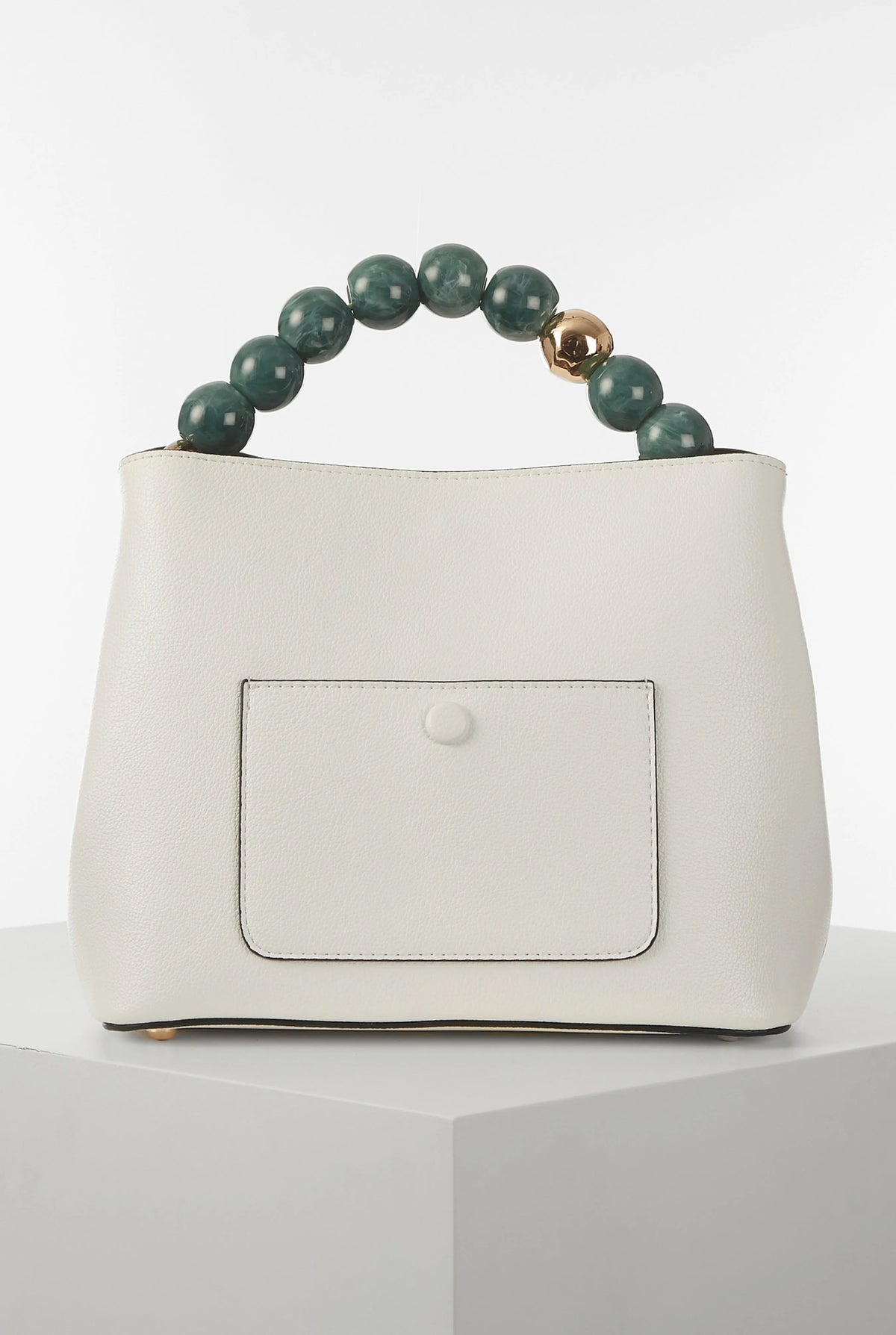 White bucket bag with centered rectangular patch pocket and green bead handle