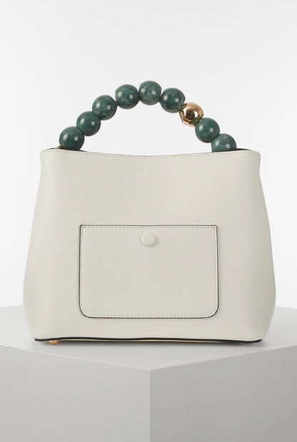 White bucket bag with centered rectangular patch pocket and green bead handle