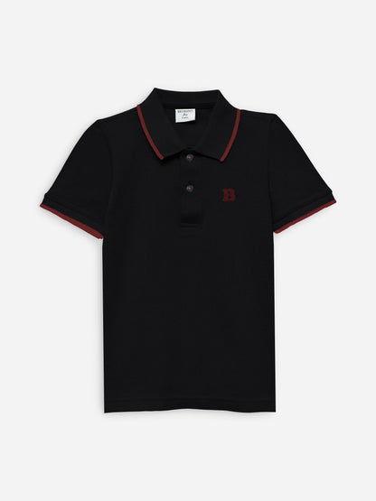 Black cotton polo shirt with red-trim collar and short sleeves, button placket
