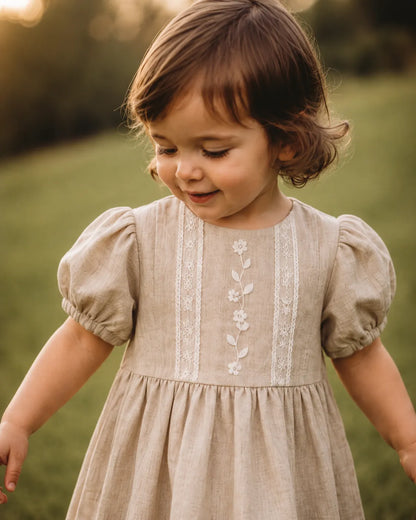 Stone baby dress with embroidered vertical floral panel, puff sleeves, gathered skirt