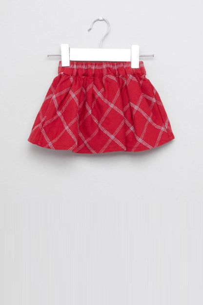 Red plaid baby skirt on hanger with bow accent