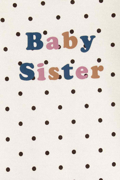 CARTER'S ivory fabric close-up with black dots and 'Baby Sister' text graphic