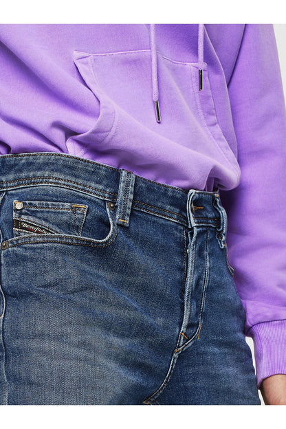 Blue denim jeans detail with front pockets and contrast stitching