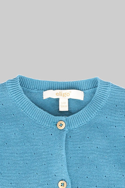 Baby knit cardigan close-up, light blue crew neck and wooden button