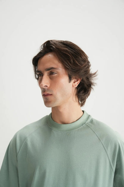 Teal crew-neck short-sleeve T-shirt close-up of collar and stitching