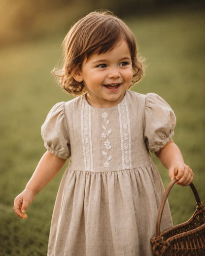 Stone baby dress with puff sleeves and vertical floral embroidery, rounded neckline