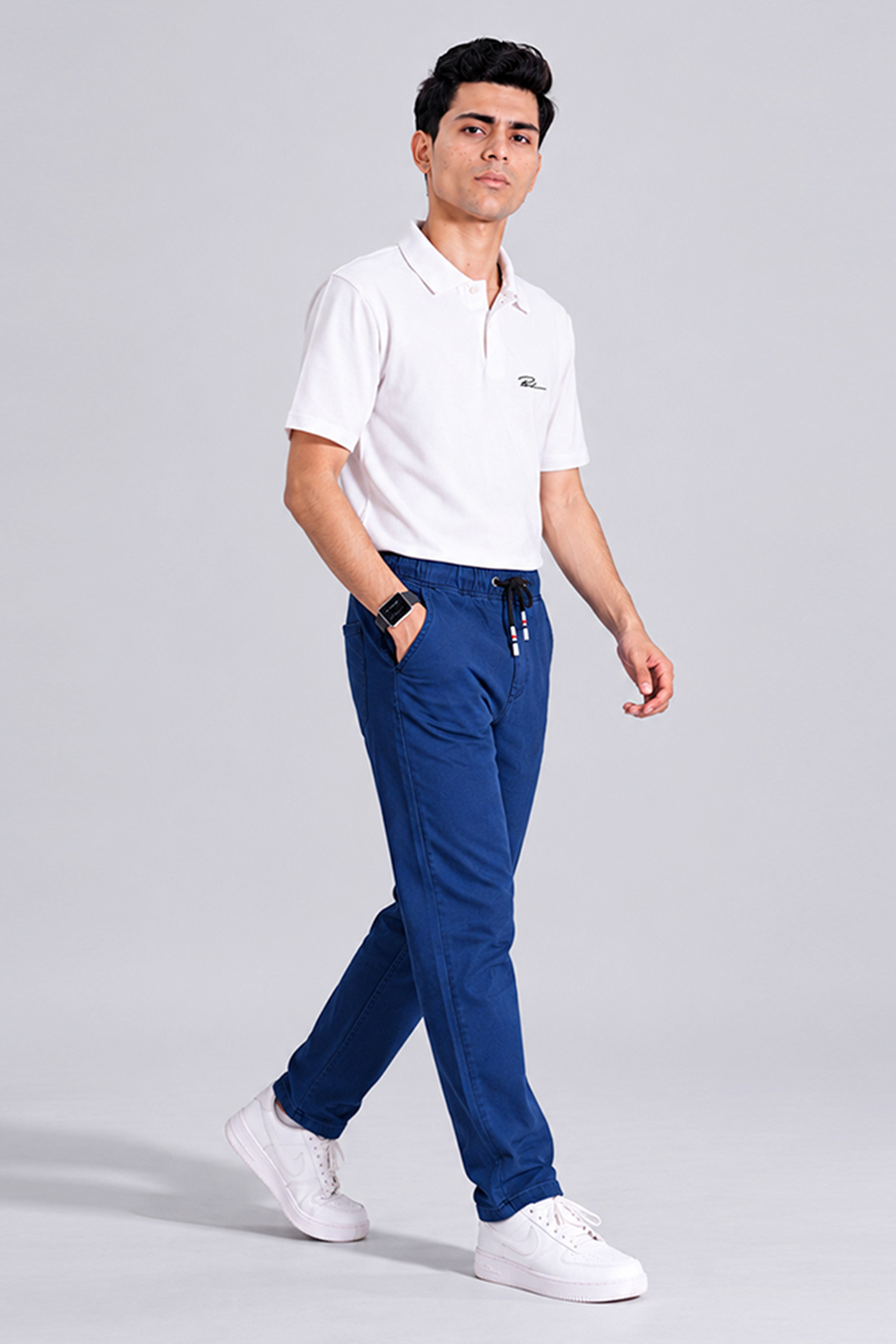 Royal blue drawstring waist chino pants, side view with cuffed legs