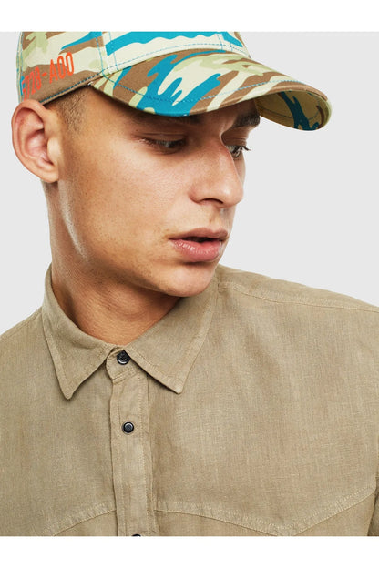 Men's beige button-up shirt close-up with pointed collar and dark button placket