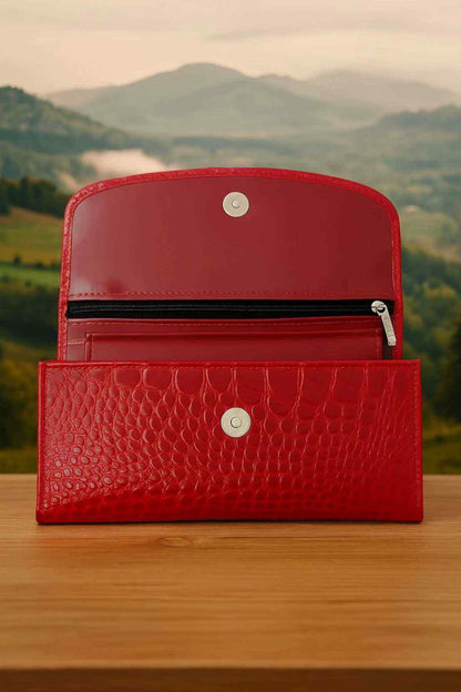 Red leather wallet open with top flap and inner card slots